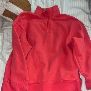 Athleta Forever Fleece Quarter-Zip Pullover. Color is a pink/red-called punch